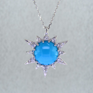 Effortlessly chic, this beautiful Turquoise star pendant in Sterling Silver goes anywhere you do. Set with a 10mm round sultry blue Turquoise, surrounded by brilliant white Sapphires. Hangs on a Sterling Silver .07mm anchor chain, 18 inches long. Pendant measures 3/4 inch long.

Handcrafted by artists in Montreal, Canada. 