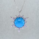 Effortlessly chic, this beautiful Turquoise star pendant in Sterling Silver goes anywhere you do. Set with a 10mm round sultry blue Turquoise, surrounded by brilliant white Sapphires. Hangs on a Sterling Silver .07mm anchor chain, 18 inches long. Pendant measures 3/4 inch long.

Handcrafted by artists in Montreal, Canada. 