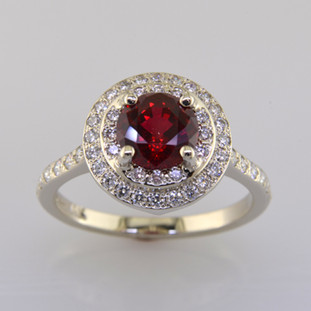 Timeless and elegant, this double halo ruby and diamond ring will never go out of style. Meticulously crafted in 14 karat white gold, with a deep red 1.50 carat Chatham Created Ruby, and .46ct T.W. of Ideal cut Diamonds. Measures 1/2 inch in diameter, in a size 6.5. Can be sized up or down. Also available with many other center gemstone options, by special order. Want it in platinum? We can do that too. 
Please let us know how we can make this ring Perfectly You.

Designed, and created in our studio by the artist Stuart J.