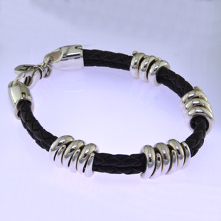 Edgy and modern, this braided leather and sterling silver man's bracelet makes a statement in a classy, understated way. The genuine leather measures 6.5mm in diameter, with solid sterling silver coils, and a sturdy clasp. Will fit an 8 inch wrist, and can be sized down only.

by David Heston of San Rafael, California.