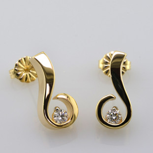 Sweet, simple, modern diamond earrings. Wear them for work or play. Crafted in 14 karat Yellow Gold with .20ct. T.W. Ideal cut Diamonds, with posts. Measure 1/2 inch long.

Designed, and created in our studio by the artist Stuart J.
