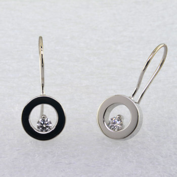 These floating diamond earrings are modern and timeless. Classic circles in 14 karat White Gold with .20ct. T.W. Ideal cut Diamonds, hanging on wires. Measure 3/4 inch long.

Designed, and created in our studio by the artist Stuart J.