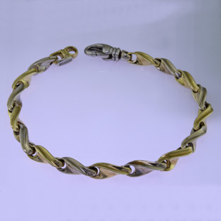 This beautiful twisted link two tone bracelet has an elegant, luxurious feel. Handcrafted in solid 14 karat yellow and white gold. Measures 7.5 inches long, and can be orderd in any size, or karat and color of gold, and platinum. How's that for options. This one, however, is ready for a wrist now.

Proudly crafted in the U.S.A.