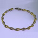 This beautiful twisted link two tone bracelet has an elegant, luxurious feel. Handcrafted in solid 14 karat yellow and white gold. Measures 7.5 inches long, and can be orderd in any size, or karat and color of gold, and platinum. How's that for options. This one, however, is ready for a wrist now.

Proudly crafted in the U.S.A.