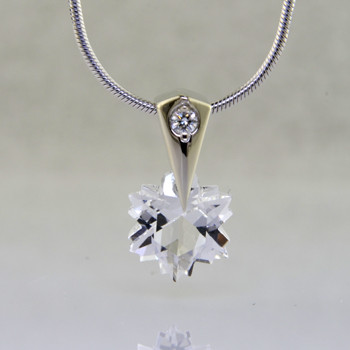 The hottest snowflake around! Custom cut, exclusively for us, in Canada. Dangling from a 14 karat white gold Piercette® pendant, with a perfectly cut sparkling 8mm Colorless Topaz snowflake cut gemstone, and accented with a single .03ct. Ideal cut Diamond. Includes a 14k white gold 1mm diameter, smooth snake chain, 16 inches long. Measures 1/2 inch long.

Designed and handmade by the artist Stuart J.

A Piercette® is a patented method of setting, with a gemstone that moves. The gem is set so that it swivels with every movement of the wearer, exhibiting extra sparkle. 