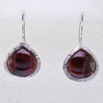 Simple, sophisticated single tear drop Amethyst earrings in rhodium plated Sterling Silver, with 12x14mm deep red Garnet cabachon pear shapes, hanging on wires. Measuring 1 1/4 inches long.

Handcrafted in northern Spain.