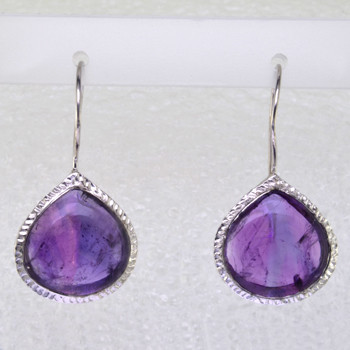 Simple, sophisticated single tear drop Amethyst earrings in rhodium plated Sterling Silver, with 12x14mm purple Amethyst cabachon pear shapes, hanging on wires. Measuring 1 1/4 inches long.

Handcrafted in northern Spain.