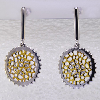 These earrings are sure to make you feel good. Edgy and modern circles in rhodium and gold plated Sterling Silver. Hanging on dangle posts, these earrings measure 1 1/2 inches long.

Handcrafted in northern Spain.