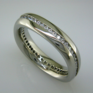 Modern man's diamond wedding ring - classy and very cool. Crafted in 14 karat White Gold, 6mm wide, with a continuous row of Ideal cut Diamonds totaling 3/4 carat. Squared shape and inside comfort fit to make this band the most comfortable it can be.

This diamond wedding ring is priced in 14k gold, and can be made in any karat or color of gold, and in platinum. Please allow 2 weeks to make it. It will be worth it!

Designed, and created in our studio by the artist Stuart J.
