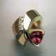 Beautiful, modern and fun. So unique, everyone will admire it. Made in 14 karat yellow gold with a sparkling 7.5mm Rhodolite Garnet Trillion gemstone, and .09ct. T.W. of ideal cut diamonds. Finger size 6.5. 

Call us for more information about how we can customize this design Just For You. Designed, and created in our studio by the artist Stuart J.