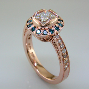 Timeless and modern cushion cut diamond halo engagement ring.

This elegant diamond engagement ring can be made in any karat or color of gold, and in platinum.

This custom designed engagement ring is individually crafted to be Perfectly You, and takes about 3-5 weeks to create. Call us for more information about how we can customize this design Just For You. Designed, and created in our studio by the artist Stuart J.

This ring is shown in 14 Karat rose gold with natural blue and white ideal cut diamonds.  We will be happy to make it any way you wish.
