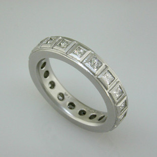 Modern and classic, this princess cut diamond anniversary ring will never go out of style. Wear it as a stacking or single ring, an anniversary ring, or a wedding ring. We can make it in any karat or color of gold, and platinum.
This custom designed anniversary ring is individually crafted to be Perfectly You, and takes about 3-5 weeks to create. Call us for more information about how we can customize this design Just For You. Designed, and created in our studio by the artist Stuart J.