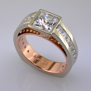 This contemporary diamond engagement ring will really make you feel special, and can be made in gold or platinum, or both. Feel modern, elegant, and cool when wearing this diamond engagement ring. Shown in 14 karat white and rose gold, with 1.10ct. of ideal princess cut diamonds, and a 6mm princess cut center (priced separately). This diamond engagement ring is great for professionals who work with their hands, because there are no prongs to catch. 

This custom designed diamond engagement ring is individually crafted, to be Perfectly You, and takes about 3-5 weeks to create. Call us for more information about how we can customize this design Just For You. Designed, and created in our studio by the artist Stuart J.