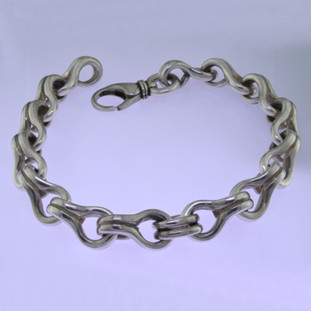 Go bold with this stylin' Sterling Silver key hole link bracelet, in a modern design. Uniquely designed for a man, it effortlessly transitions from casual to dressy. Weighs about 1 3/4 ounces, and measures about 3/8 inch wide and 8 1/2 inches long.

by David Heston of San Rafael, California.