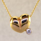 This lovely puffed heart pendant will make you feel happy every day. The ultimate fun heart with a .10ct. sparkling diamond. This 14 karat yellow gold heart measures 1/4 inch long, and hangs on a 14 karat yellow gold 1mm cable chain, 18 inches long. 

Designed, and created in our studio by the artist Stuart J.