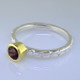This cool, hip, and fun stackable ring is the start of your new collection. This ring will have many different looks when you stack it with other rings, or enjoy it alone in your everyday style. Hand finished in Sterling sliver with an 18 karat yellow gold bezel holding a beautiful .65ct.round rhodolite garnet. Finger size 7. We will make this in any size you need in about ten days.

Designed, and created in our studio by the artist Stuart J.

This ring is also shown in other gemstone colors and sizes, which are sold separately, and can be stacked with all other rings in our stackables collection. You can also stack it with any ring you like. There are no rules. Call us with your favorite color, and we will customize this Just For You.