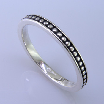 This cool, hip, and fun stackable ring is the start of your new collection. This ring will have many different looks when you stack it with other rings, or enjoy it alone in your everyday style. Hand finished in Sterling sliver with a beautiful ball design. Finger size 7. We will make this any size you need in about 10 days. Band measures 2.5mm wide. 

Designed, and created in our studio by the artist Stuart J.

This ring is also shown with other gemstone colors and sizes, which are sold separately, and can be stacked with all other rings in our stackables collection. You can also stack it with any ring you like. There are no rules. Call us with your favorite color, and we will customize this Just For You.