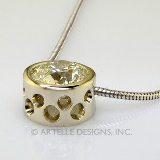 Ladies white gold custom designed diamond bezel pendant with circle cut outs on a snake chain. Simple is always best!