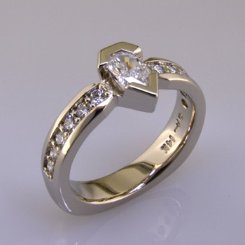 Wed 319- Our customer was ready for a new diamond engagement ring style, so we custom made a new diamond ring using her old stones.  Now, it is new again.  14 karat white gold, and we added a few new diamonds to make this wedding ring modern, and elegant.  We do love to recycle!