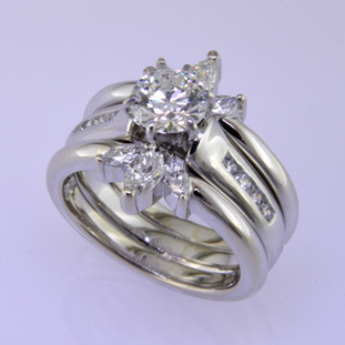 Wed 324-  How to make a diamond solitare engagement ring look modern?  We custom designed these 2 bands to hug the center diamond solitare, and now this ring is fresh and modern. 14 karat white gold with 6-sparkly marquise diamonds brought this ring to life.  Perfect!