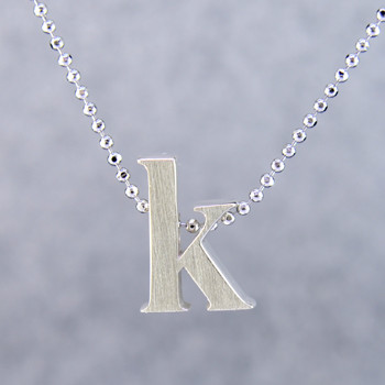 What's your story? Begin with this Little "K" initial solid Sterling Silver pendant. Wear it alone, with other pendants, or layered with other necklaces. Comes with a sterling silver ball chain, 16 inches long. The pendant measures 1/4 inch long. Too cute!

Signified by a feminine sensibility and optimistic charm, Alex Woo's Little Icon Collections reinvent familiar symbols from the world around us into fresh and expressive designs.

Designed and handcrafted in our studio.