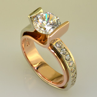 You will make a statement wearing this contemporary diamond engagement ring. Elegant flowing lines and contrasting metals make this design both modern and timeless. Shown in 14 karat white and rose gold, with 0.30ct. of round brilliant ideal cut diamonds, and a 1.50ct. center diamond (priced separately or we can use your diamond). We are happy to customize this special engagement ring any way you like, including using different metals like 18k yellow gold and platinum, and using your diamonds.

This custom designed diamond engagement ring is individually crafted, to be Perfectly You, and takes about 3-5 weeks to create. Call us for more information about how we can customize this design Just For You. Designed, and created in our studio by the artist Stuart J.