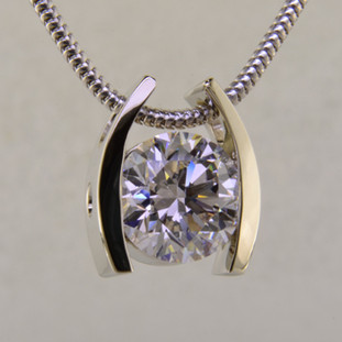 Ladies white gold custom designed solitare pendant.
