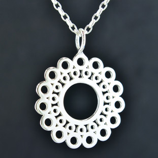 Playful and bright, this sunburst pendant is a delight to wear. Sterling Silver with a sunburst flower pattern and hangs on a 2mm Sterling Silver long link chain, 18 inches long. Pendant measures 1 1/2 inches long.

Created and handmade by master jeweler Stuart J.