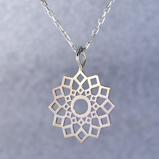 Playful and bright, this snowburst pendant is a delight to wear. Sterling Silver with a snowflake pattern and hangs on a 1mm Sterling Silver oval link chain, 18 inches long. Pendant measures 1 1/2 inches long.

Created and handmade by master jeweler Stuart J.
