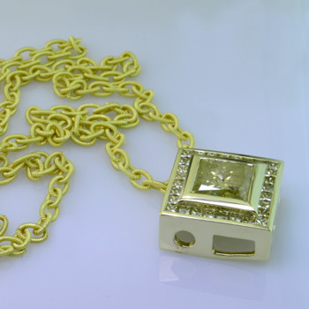 14 Karat green gold custom designed pendant with natural yellow princess cut diamonds and a 4ct. Princess cut yellow diamond center.