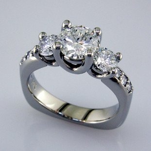 This beautiful diamond engagement ring design with its simple, clean lines frames your diamond perfectly. The bottom has soft rounded corners for the ultimate comfort. This is a vintage inspired, but timeless design.  

This elegant diamond engagement ring is priced in 14k white gold, and can be made in any karat or color of gold, and in platinum. Set with .59ct. of ideal cut diamonds, this one is shown with a 2 carat brilliant round cut center (sold seperately), but we will make it for any size. A matching shadow wedding ring or a diamond wedding ring is available.(sold seperately)

This custom designed engagement ring is individually crafted to be Perfectly You, and takes about 2 weeks to create. Call us for more information about how we can customize this design Just For You. Designed, and created in our studio by the artist Stuart J.