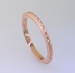 Sleek and modern rose gold diamond wedding ring to match our Katie Rose, or to wear seperately as an eternity or stackable ring. This diamond ring has 32 sparkling ideal cut diamonds weighing .16ct. Made in a size 6 3/4. Call for other sizes, or other gold options.

Made in our studio by the artist Stuart J.