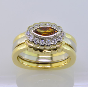 These fitted wedding rings perfectly compliment our Ginger engagement ring. Hand crafted in 18 karat yellow gold to bring out the color of the yellowish orange diamond center. The 2 wedding rings create the perfect frame to show off Ginger to her fullest. In case you only want to get one, they are priced individually. And, of course, we can make them in any color or karat of gold or platinum, or even with diamonds. Now there's an idea!

Custom designed and hand crafted in our studio by the artist Stuart J. 