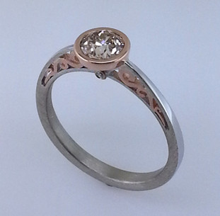 Blending old world charm with contemporary style, this diamond engagement ring brings grace and elegance to the wearer. Hand crafted in 18 karat white and rose gold, with .01ct. total weight of diamonds adding a little extra sparkle. And to top this elegant ring off, a .59ct. European cut round light champagne natural color diamond.

Designed by the acclaimed artist Alishan in his California studio.  All designs can be made any way you like, with any gemstones you like.