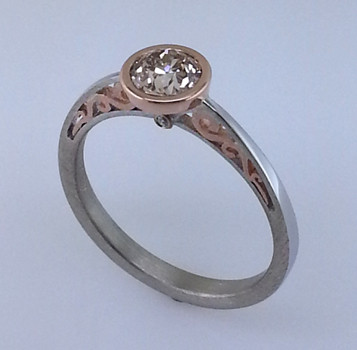 Blending old world charm with contemporary style, this diamond engagement ring brings grace and elegance to the wearer. Hand crafted in 18 karat white and rose gold, with .01ct. total weight of diamonds adding a little extra sparkle. And to top this elegant ring off, a .59ct. European cut round light champagne natural color diamond.

Designed by the acclaimed artist Alishan in his California studio.  All designs can be made any way you like, with any gemstones you like.