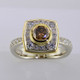 Here is a diamond halo engagement ring with a sophisticated flare. Custom designed with .45. T.W. of pavé set ideal cut diamonds makes this ring sparkle like crazy! A beautiful .57ct. round natural cognac color diamond is the focal point of this uniquely styled pavé halo diamond ring. It is set in an 18 karat yellow gold bezel to accentuate its vivid color, and also happens to make it look more like a one carat diamond! And not a single prong to worry about! This pavé diamond engagement ring feels smooth and is easy to wear. It is hand made in 14 karat white gold, with an 18 karat yellow gold border to beautifully frame the diamond halo. You will love the custom touches on this sweet engagement ring, like the beautiful open design on the underside. 
As with all of our designs, we will make this any way you like, with any gemstones you like.

Custom designed and hand crafted in our studio by the artist Stuart J.