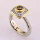 Here is a diamond halo engagement ring with a sophisticated flare. Custom designed with .45. T.W. of pavé set ideal cut diamonds makes this ring sparkle like crazy! A beautiful .57ct. round natural cognac color diamond is the focal point of this uniquely styled pavé halo diamond ring. It is set in an 18 karat yellow gold bezel to accentuate its vivid color, and also happens to make it look more like a one carat diamond! And not a single prong to worry about! This pavé diamond engagement ring feels smooth and is easy to wear. It is hand made in 14 karat white gold, with an 18 karat yellow gold border to beautifully frame the diamond halo. You will love the custom touches on this sweet engagement ring, like the beautiful open design on the underside. 
As with all of our designs, we will make this any way you like, with any gemstones you like.

Custom designed and hand crafted in our studio by the artist Stuart J.