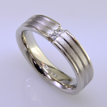 Modern mans diamond wedding ring - classy and very cool. Crafted in 14 karat white gold, it's 6mm wide, with three continuous grooved lines, featuring two princess cut diamonds totaling one tenth carat. This ring has a rounded shape and comfort fit inside to make this ring the most comfortable it can be. Finger size is 11, and it can be sized, or custom made Just For You.

This diamond wedding ring is priced in 14k gold, and can be made in any karat or color of gold, and in platinum. Please allow 2 weeks for us to make it. It will be worth it!

Designed, and created in our studio by the artist Stuart J.