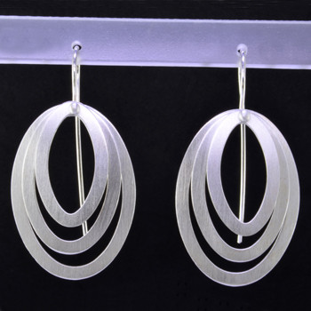 These earrings are sure to make you feel good. Edgy and modern ovals in Sterling Silver. Hanging silver wires, these earrings measure 1 1/2 inches long.  

Handcrafted in Istanbul.