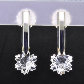 What's better than one sparkling snowflake? Two, of course. One for each ear. And you can turn up the heat, because these snowflakes won't melt. Exclusively ours, each colorless topaz snowflake is custom cut just for us, in Canada, by master gem cutters. Each snowflake measures 8mm, and dangles in a sterling silver Piercette® setting on a post, measuring 1 inch long.

Designed, and created in our studio by the artist Stuart J.

A Piercette® is a patented method of setting, with a gemstone that moves. The gem is set so that it swivels with every movement of the wearer, exhibiting extra sparkle.