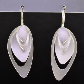 These sculptural Sterling Silver earrings are amazing. Handmade in Istanbul, beautiful triple tier design, with a soft feel and bold look. These earrings look like true art. The wire feeds through the ear, hanging in the perfect place. Definitely a statement piece. These earrings measure 1 3/4 inches long. 