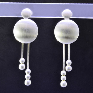  Fun, and funky earrings for the adventurous girl. Sterling silver dangles with round shapes, dangling on wires accented with small round silver beads, resting on posts. You will love these earrings! Measures 1 3/4 inch long, and handmade in Istanbul.