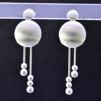  Fun, and funky earrings for the adventurous girl. Sterling silver dangles with round shapes, dangling on wires accented with small round silver beads, resting on posts. You will love these earrings! Measures 1 3/4 inch long, and handmade in Istanbul.
