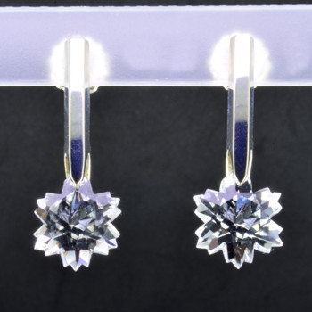 What's better than one sparkling snowflake? Two, of course. One for each ear. And you can turn up the heat, because these snowflakes won't melt. Exclusively ours, each colorless topaz snowflake is custom cut just for us, in Canada, by master gem cutters. Each snowflake measures 10mm, and dangles in a sterling silver Piercette® setting on a post, measuring 1 inch long.

Designed, and created in our studio by the artist Stuart J.

A Piercette® is a patented method of setting, with a gemstone that moves. The gem is set so that it swivels with every movement of the wearer, exhibiting extra sparkle.