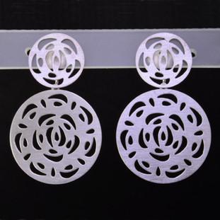 Playful and bright, these double circle open filagree dangle earrings are a delight to wear and they will make you smile. Crafted in Sterling Silver with a floral pattern, hanging on posts, and measuring 1 1/4 inches long. 

Handmade in Istanbul, Turkey.