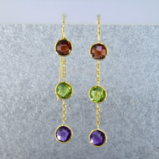Fun dangles you can wear day or night. 14 karat yellow gold 3 stone dangle with amethyst, peridot, and garnet gemstones set delicately in simple bezels and hanging on wires. Measure 2 inches long. 
