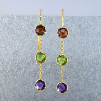 Fun dangles you can wear day or night. 14 karat yellow gold 3 stone dangle with amethyst, peridot, and garnet gemstones set delicately in simple bezels and hanging on wires. Measure 2 inches long. 