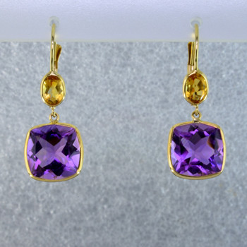 Beautiful delicate drop dangles you can wear day or night. 14 karat yellow gold with antique cushion cut amethyst gemstone and a pear shaped citrine gemstone hanging above. hangs on lever backs and measures 1 inch long.