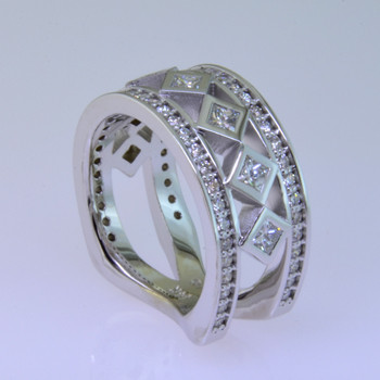 With this spectacular diamond anniversary ring on your finger, you will feel like royalty, and be the envy of all of your friends. With 1.13 carats of Ideal cut diamonds, Sparkle is this rings middle name. There are no prongs to catch, and it is very comfortable to wear. Made with a mix of round diamonds and princess cut diamonds, it is a feeling of traditional with a modern flare. This custom designed diamond anniversary ring is individually crafted to be Perfectly You. Call us for more information about how we can customize this design Just For You. 

Designed, and created in our studio by the artist Stuart J.

This diamond anniversary ring is priced in 14k gold, and can be made in any karat or color, and in platinum. Makes a great anniversary gift for 10, 20, 30 or more years together.