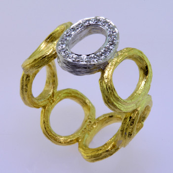  Inspired by natural colors and shapes this sophisticated diamond ring is made in 19 karat yellow gold with a continuous open oval link olive branch design. The center oval is 18 karat white gold surrounded in .14ct. of sparkling diamonds, truly making this a knock out piece. Exceptional in every way. Designed by the acclaimed artist Aaron Henry in his California studio. This ring is a size 6 1/2, but can be customized for your finger size. Please allow 3-4 weeks for special orders.
